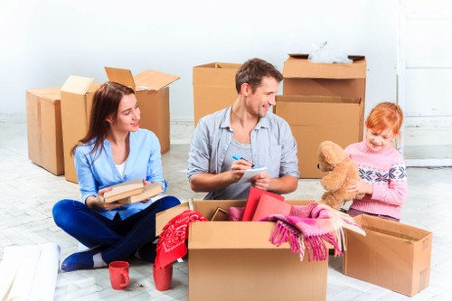 Moving team planning a home relocation in Roehampton with boxes and furniture ready for transport