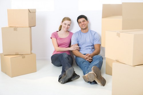 Professional movers preparing heavy furniture for transport in Roehampton